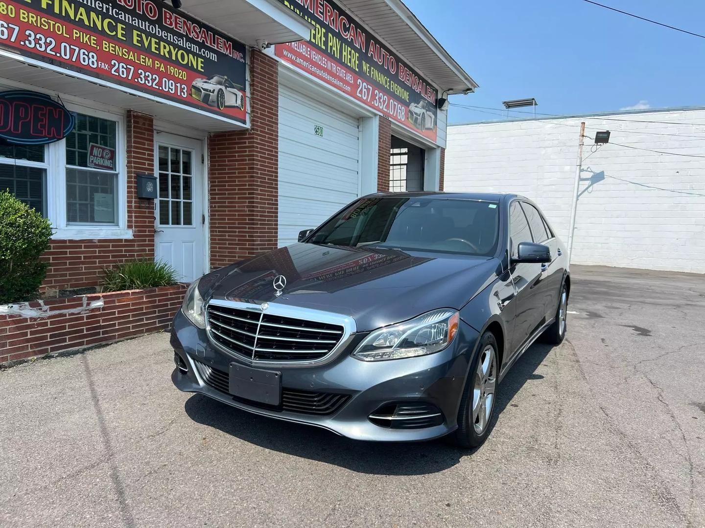 A 2014 Mercedes-Benz E-Class luxury sedan, featuring a sleek design with elegant curves, iconic front grille, and stylish headlights.