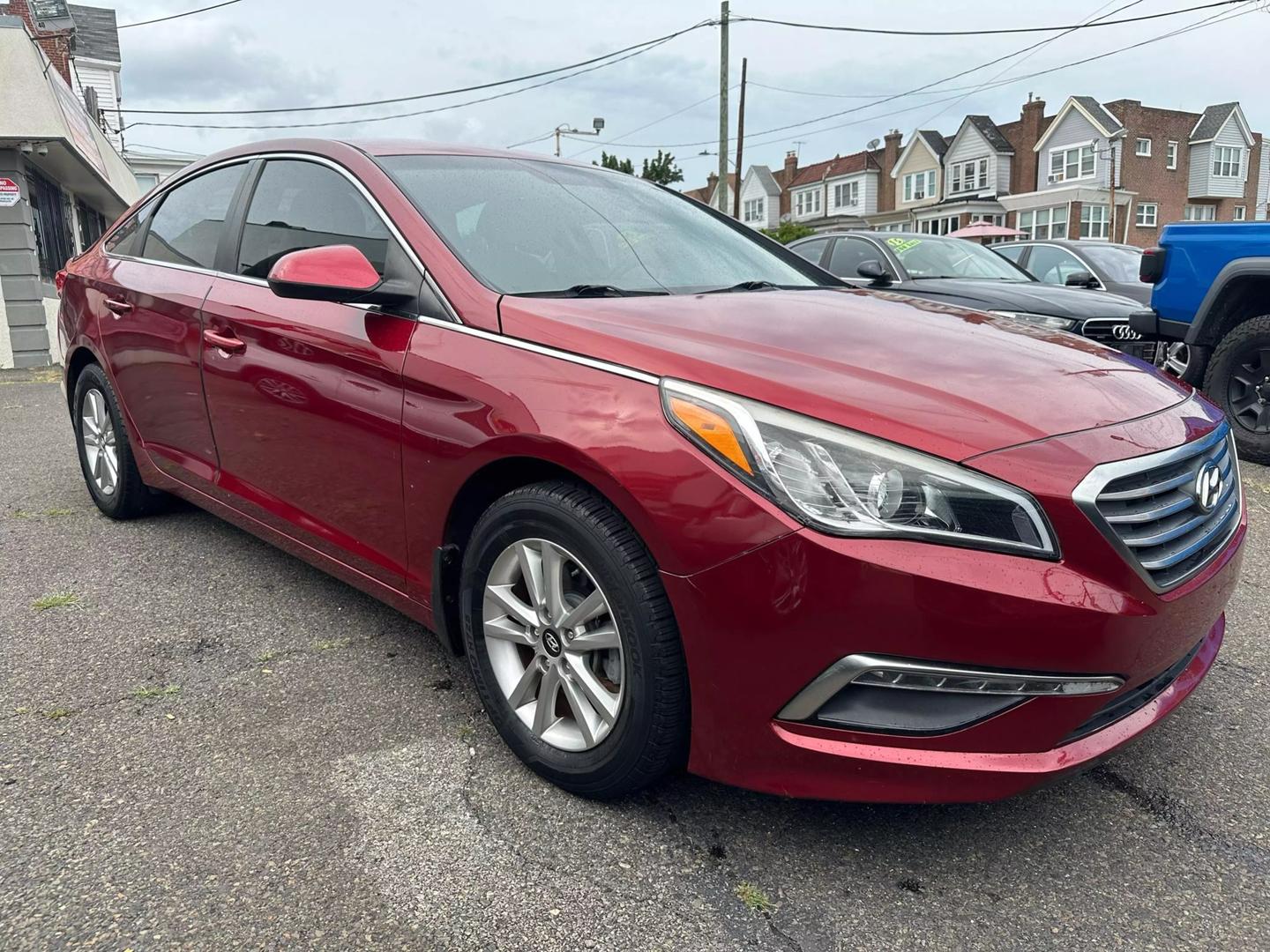 A sleek 2015 Hyundai Sonata parked outdoors, showcasing its modern design and aerodynamic profile.