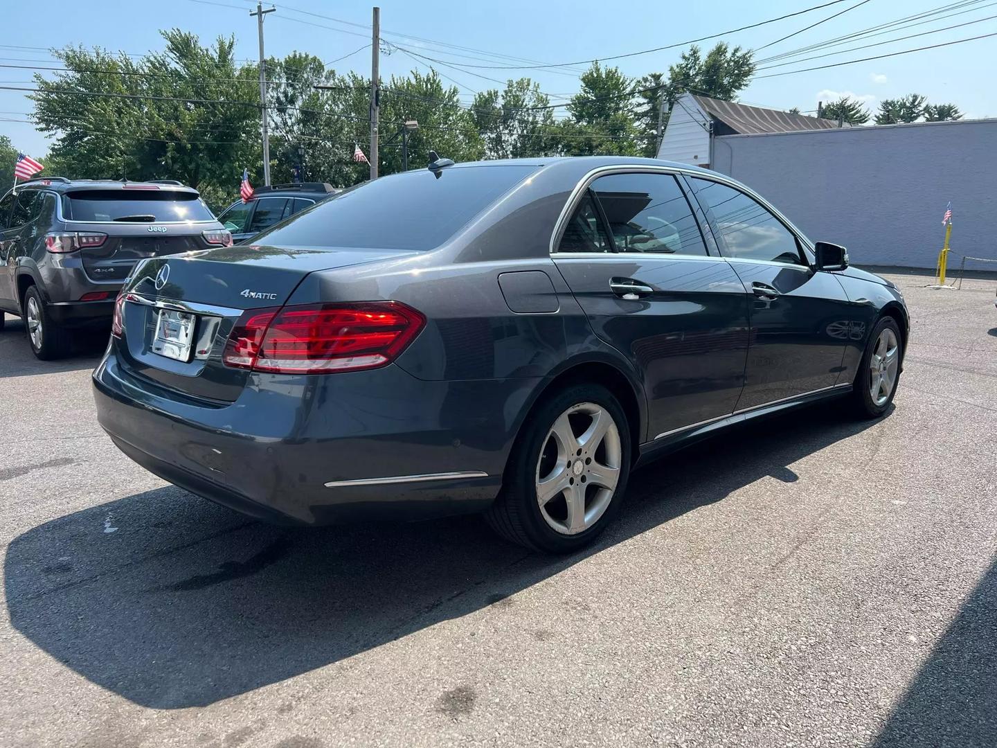 A 2014 Mercedes-Benz E-Class luxury sedan, featuring a sleek design with elegant curves, iconic front grille, and stylish headlights.