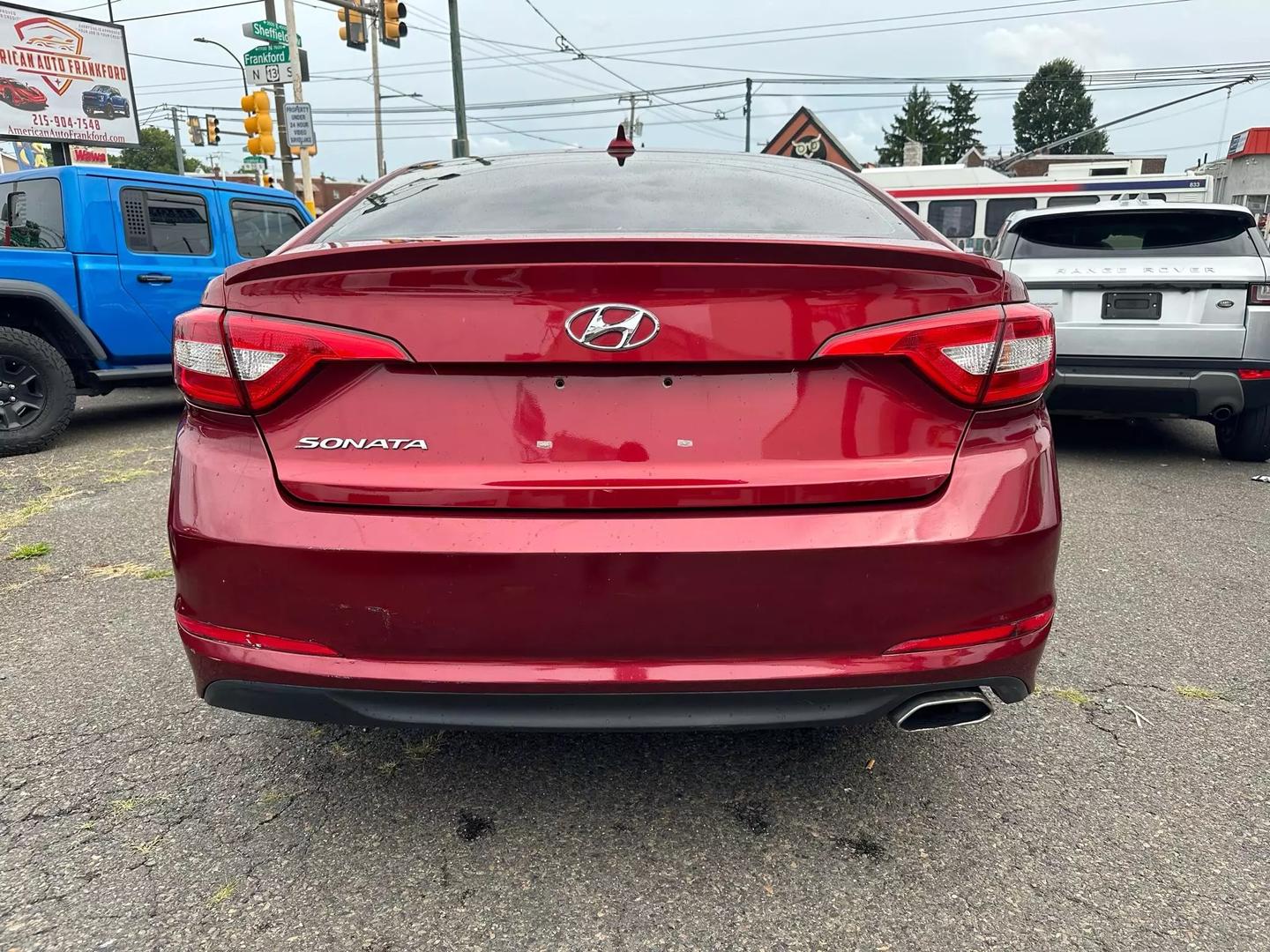 A sleek 2015 Hyundai Sonata parked outdoors, showcasing its modern design and aerodynamic profile.