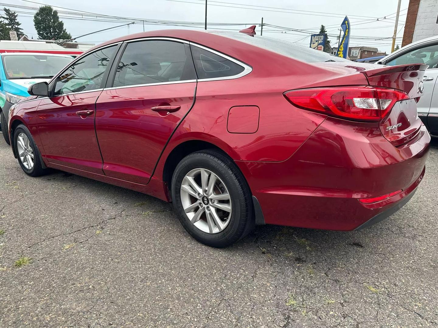 A sleek 2015 Hyundai Sonata parked outdoors, showcasing its modern design and aerodynamic profile.