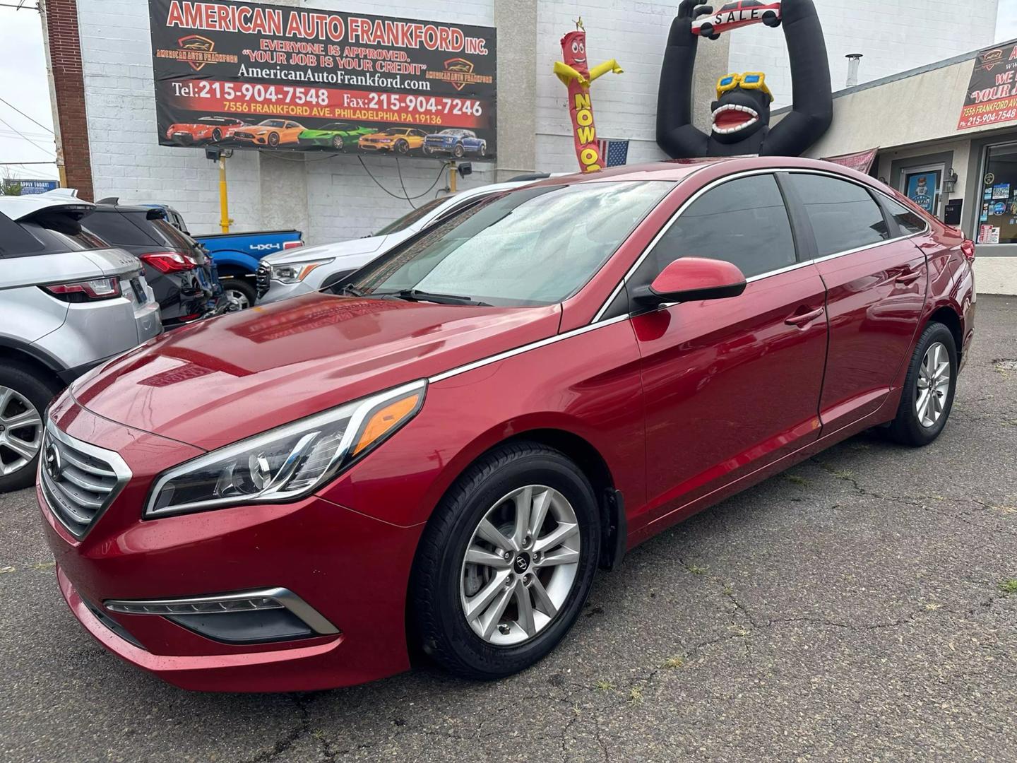 A sleek 2015 Hyundai Sonata parked outdoors, showcasing its modern design and aerodynamic profile.