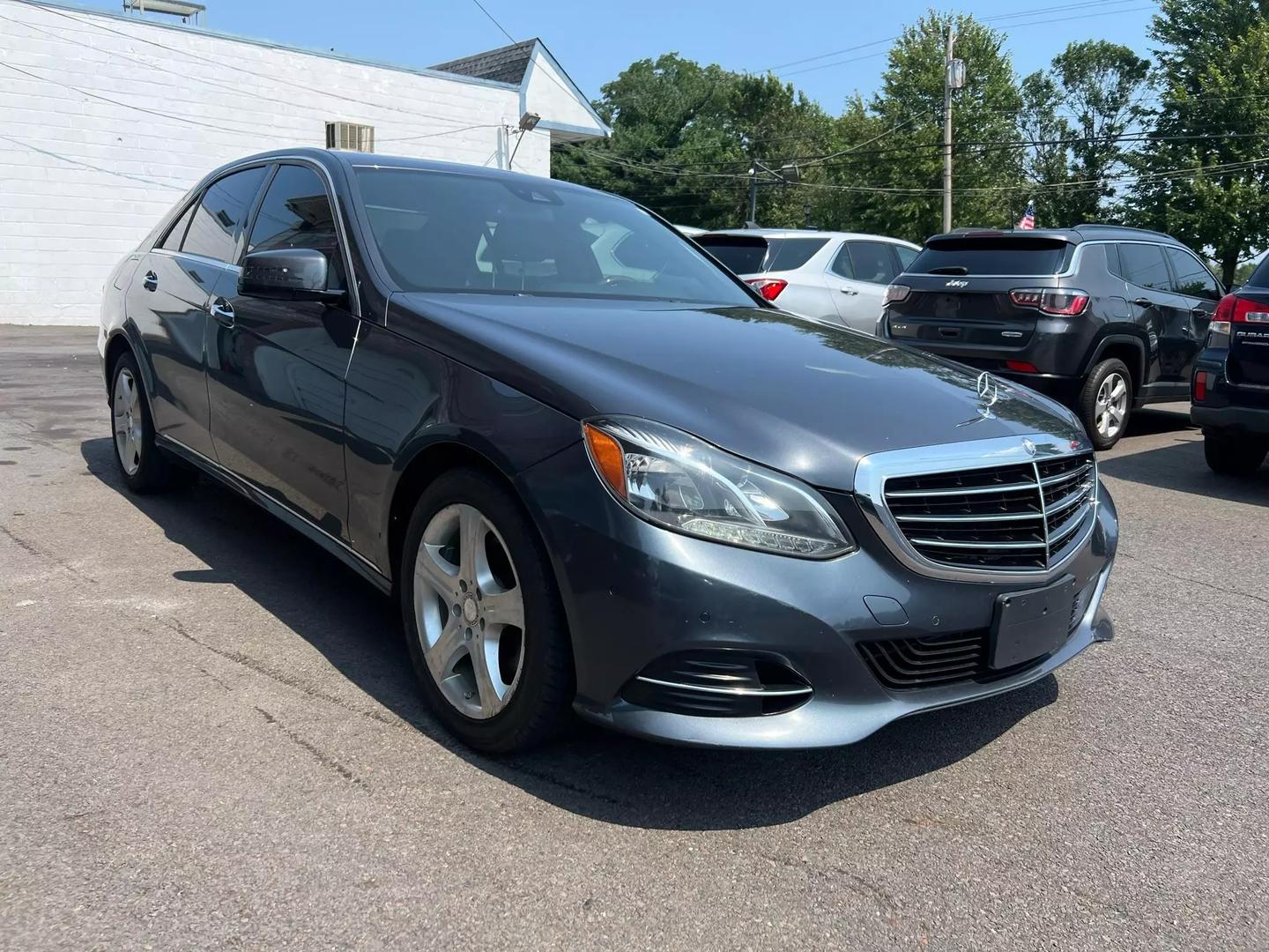 A 2014 Mercedes-Benz E-Class luxury sedan, featuring a sleek design with elegant curves, iconic front grille, and stylish headlights.