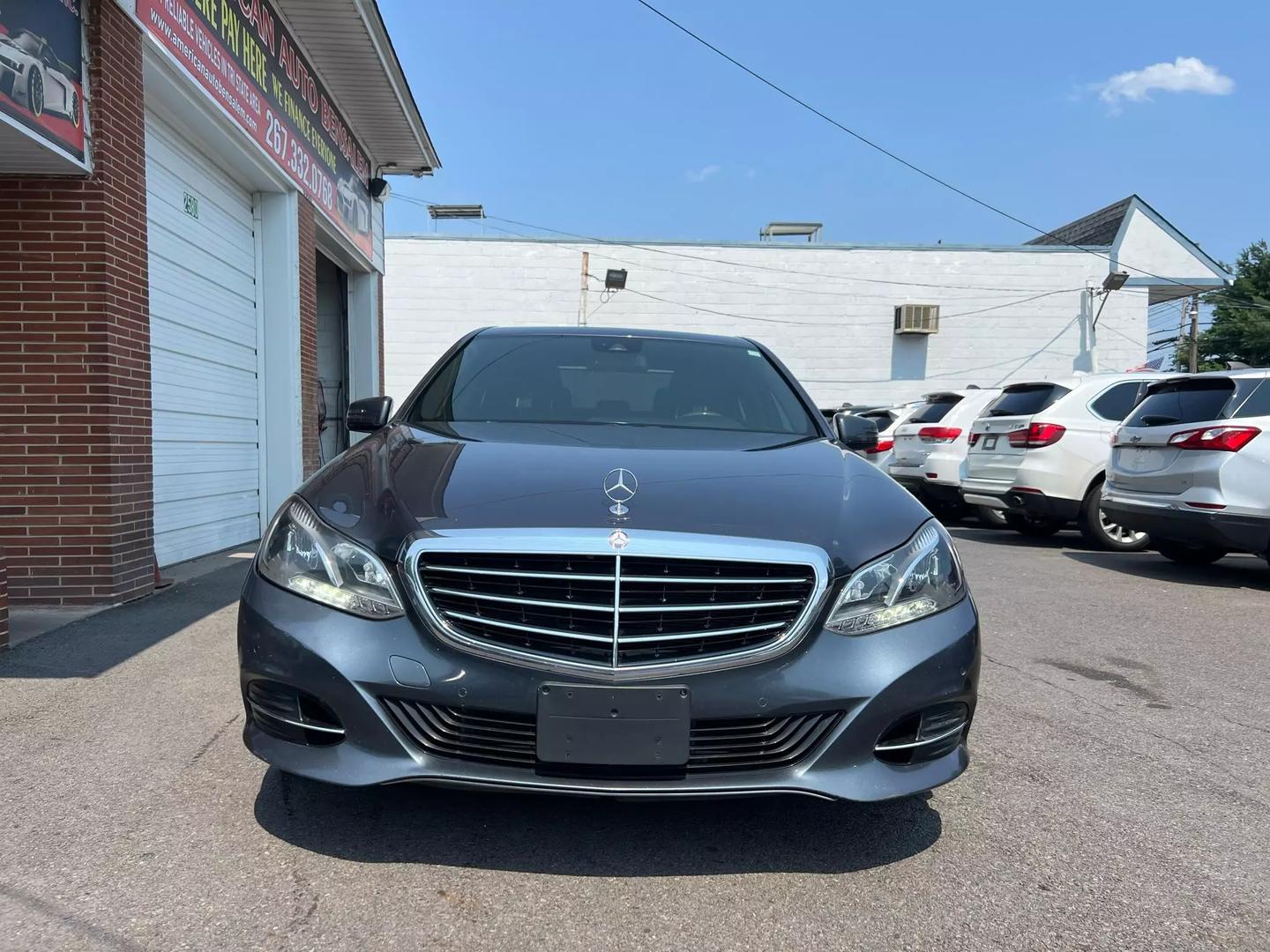 A 2014 Mercedes-Benz E-Class luxury sedan, featuring a sleek design with elegant curves, iconic front grille, and stylish headlights.