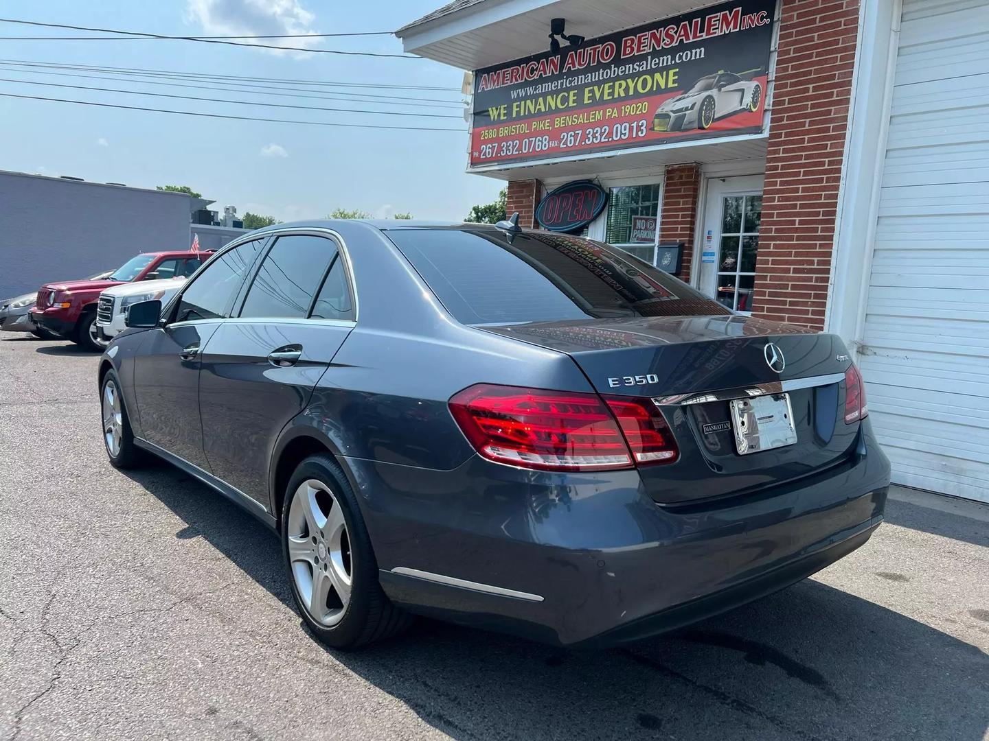 A 2014 Mercedes-Benz E-Class luxury sedan, featuring a sleek design with elegant curves, iconic front grille, and stylish headlights.