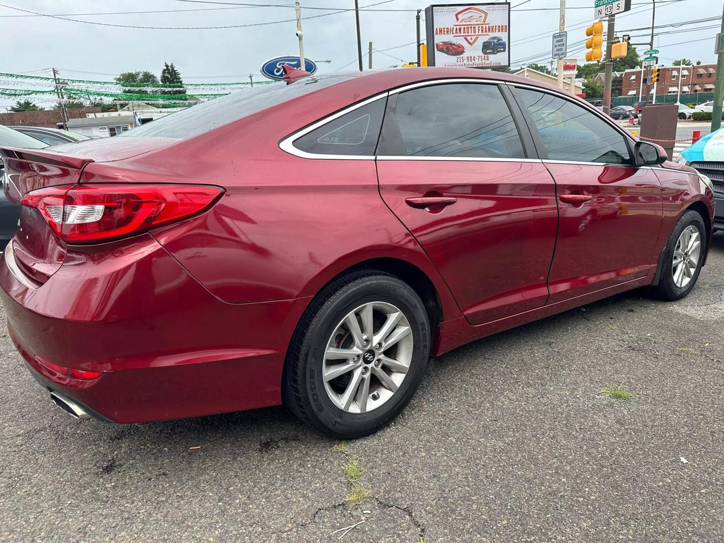 A sleek 2015 Hyundai Sonata parked outdoors, showcasing its modern design and aerodynamic profile.