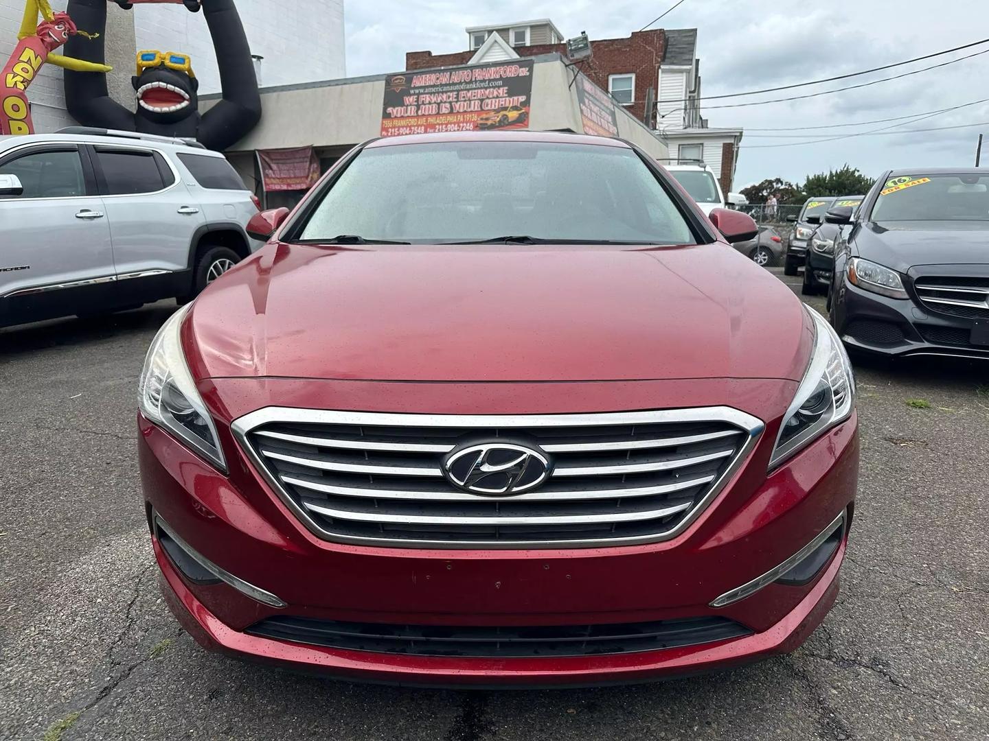 A sleek 2015 Hyundai Sonata parked outdoors, showcasing its modern design and aerodynamic profile.