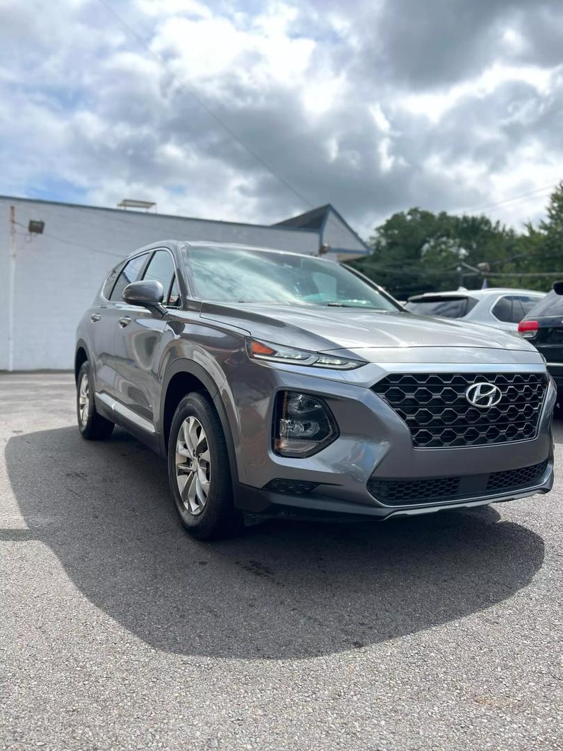 2019 Hyundai Santa Fe SUV in grey, showcasing spacious 5-seat interior, modern design, and advanced safety features, ideal for comfortable family travel and road trips.