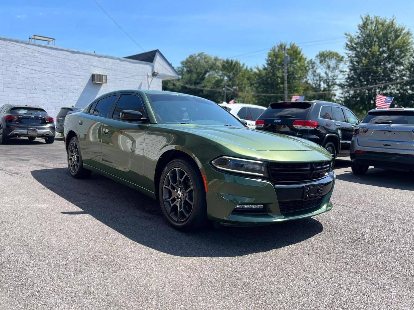 Front view of the 2018 Dodge Charger showcasing its bold, muscular design, distinctive grille, and sleek headlights.