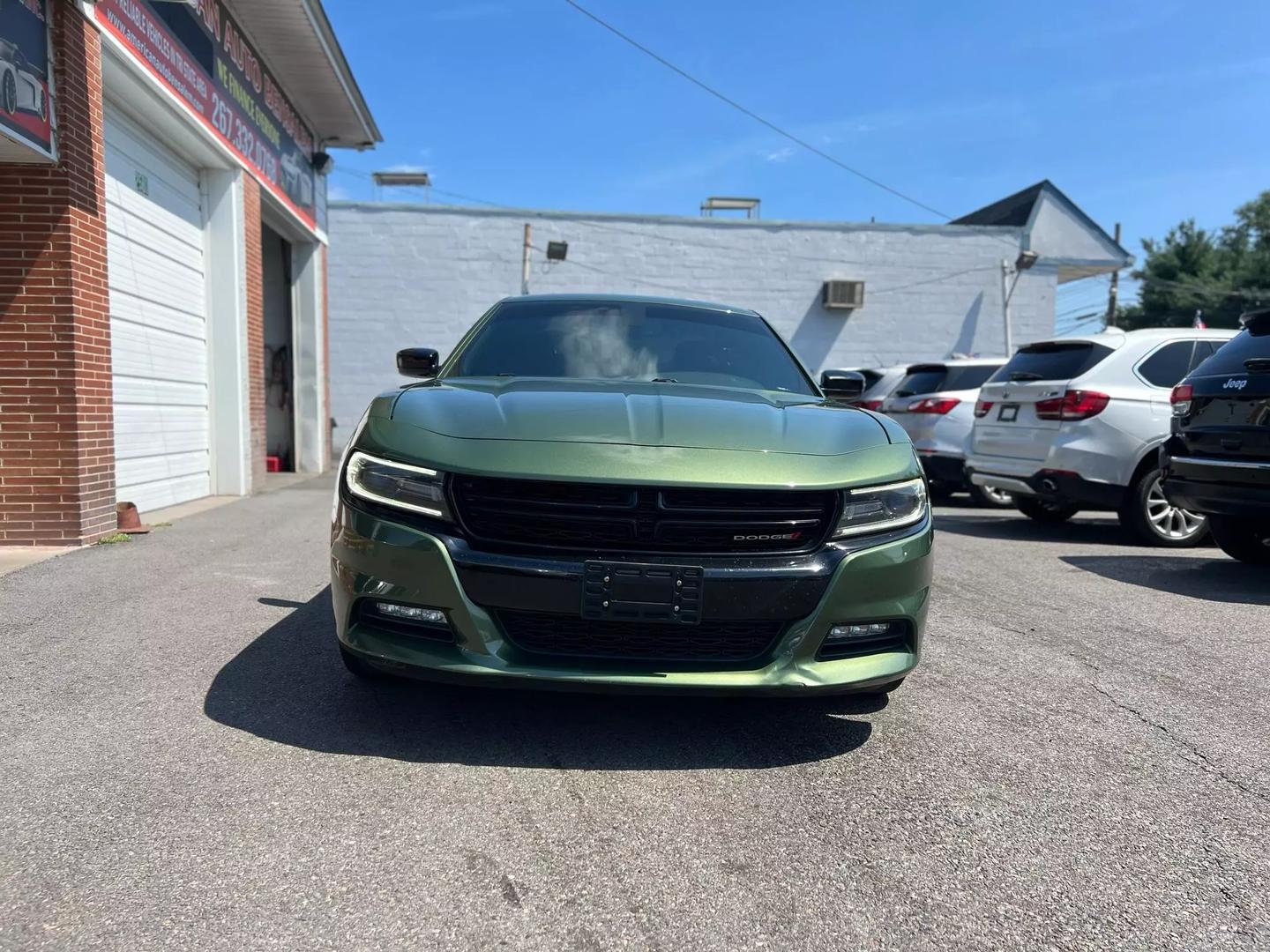 Front view of the 2018 Dodge Charger showcasing its bold, muscular design, distinctive grille, and sleek headlights.