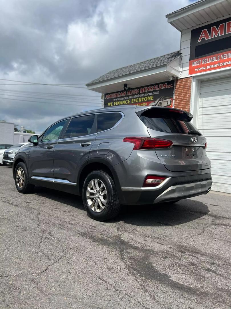 2019 Hyundai Santa Fe SUV in grey, showcasing spacious 5-seat interior, modern design, and advanced safety features, ideal for comfortable family travel and road trips.