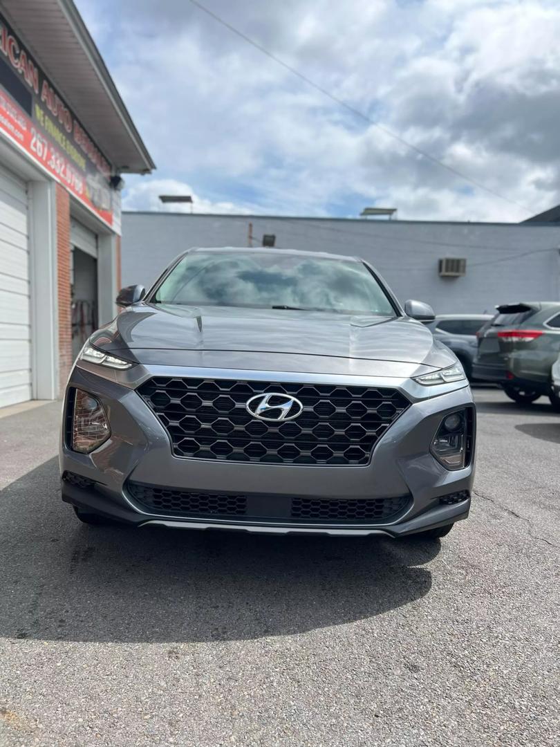 2019 Hyundai Santa Fe SUV in grey, showcasing spacious 5-seat interior, modern design, and advanced safety features, ideal for comfortable family travel and road trips.