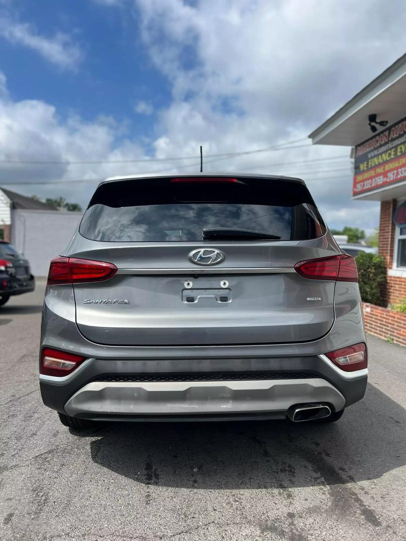 2019 Hyundai Santa Fe SUV in grey, showcasing spacious 5-seat interior, modern design, and advanced safety features, ideal for comfortable family travel and road trips.