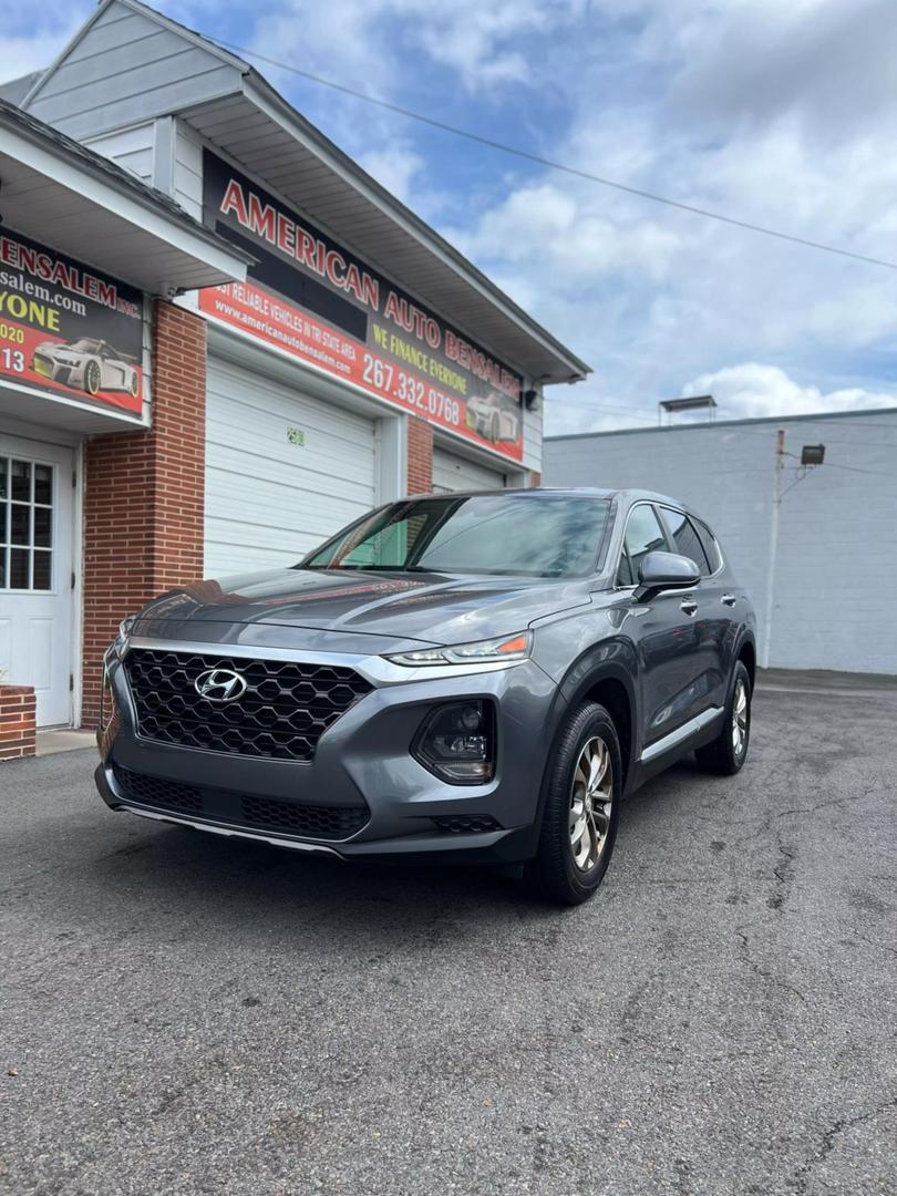 2019 Hyundai Santa Fe SUV in grey, showcasing spacious 5-seat interior, modern design, and advanced safety features, ideal for comfortable family travel and road trips.