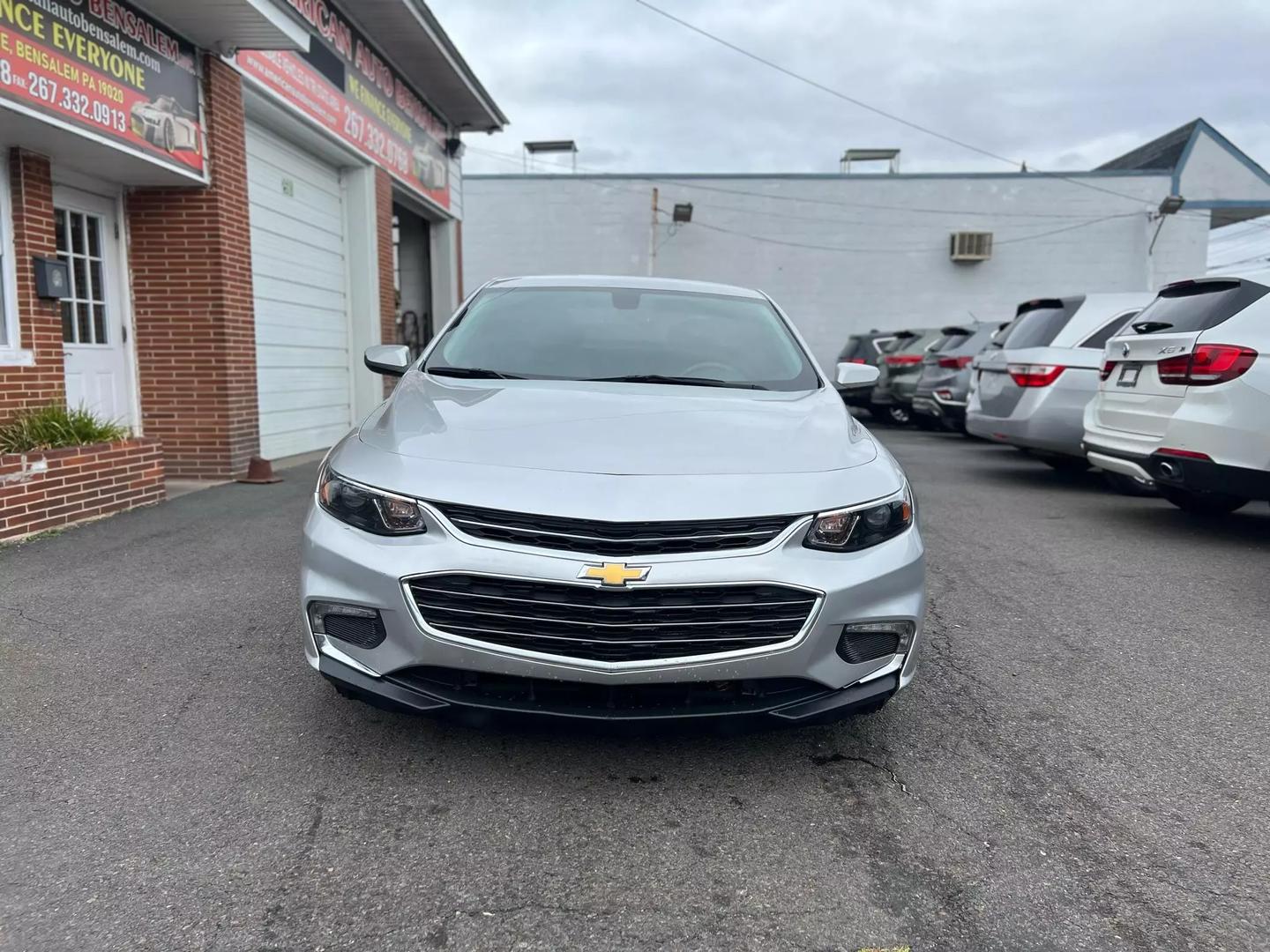 2018 Chevrolet Malibu, a sleek silver sedan with a modern design and stylish alloy wheels.