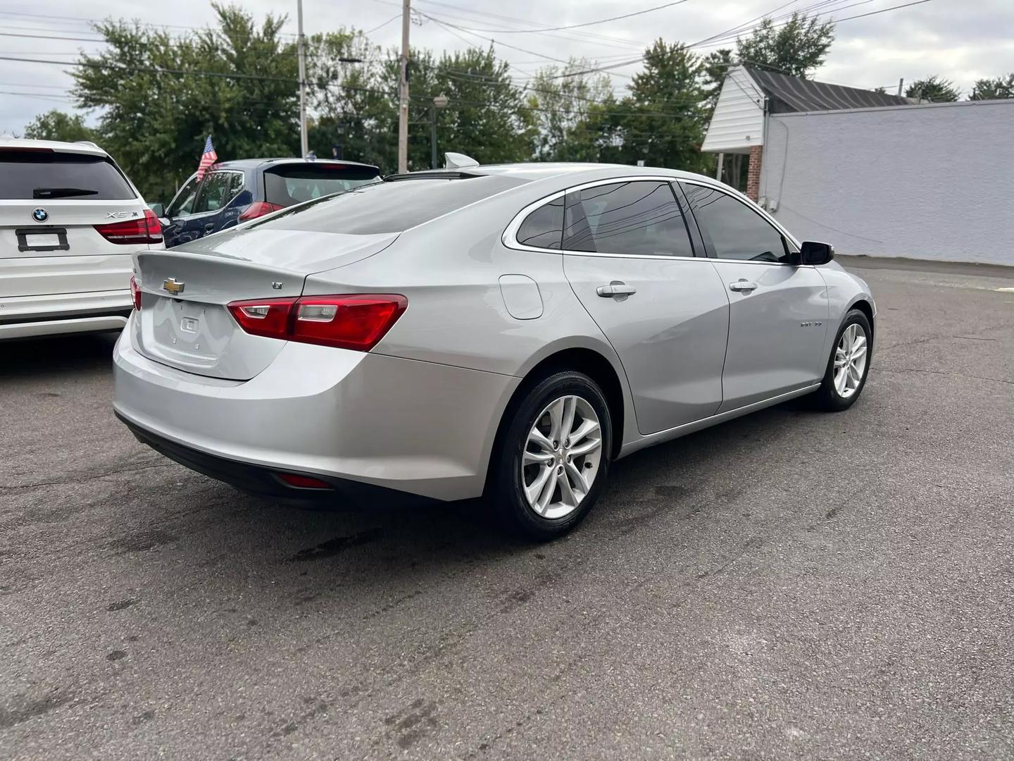 2018 Chevrolet Malibu, a sleek silver sedan with a modern design and stylish alloy wheels.