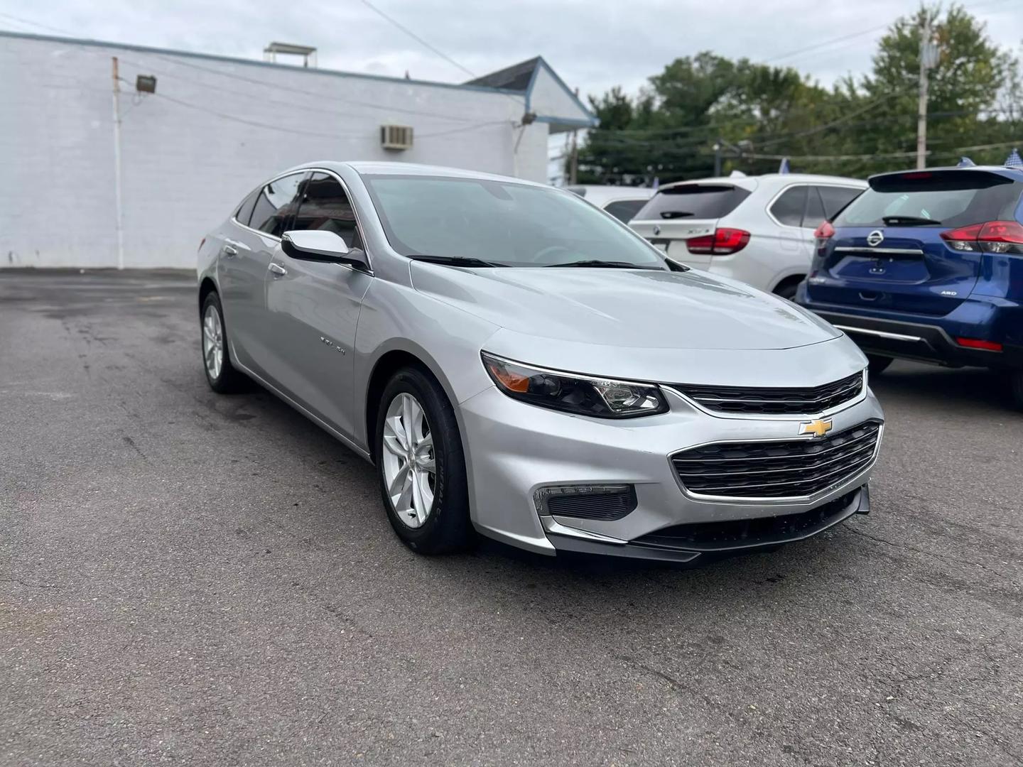 2018 Chevrolet Malibu, a sleek silver sedan with a modern design and stylish alloy wheels.