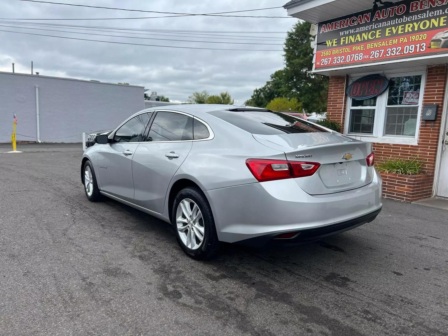 2018 Chevrolet Malibu, a sleek silver sedan with a modern design and stylish alloy wheels.