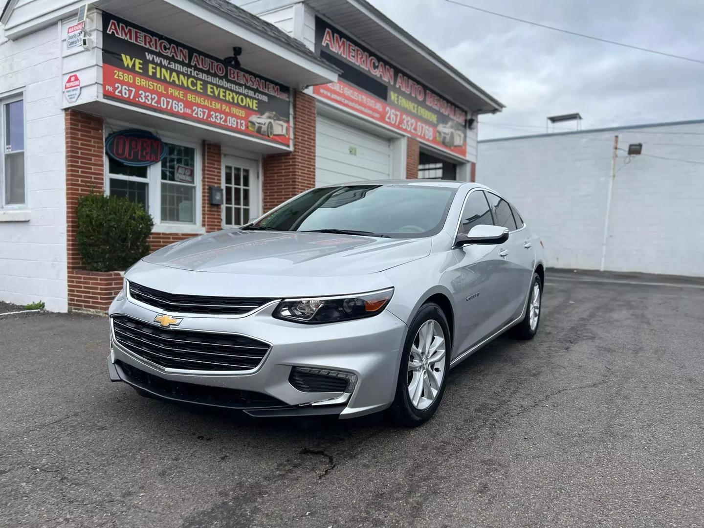 2018 Chevrolet Malibu, a sleek silver sedan with a modern design and stylish alloy wheels.