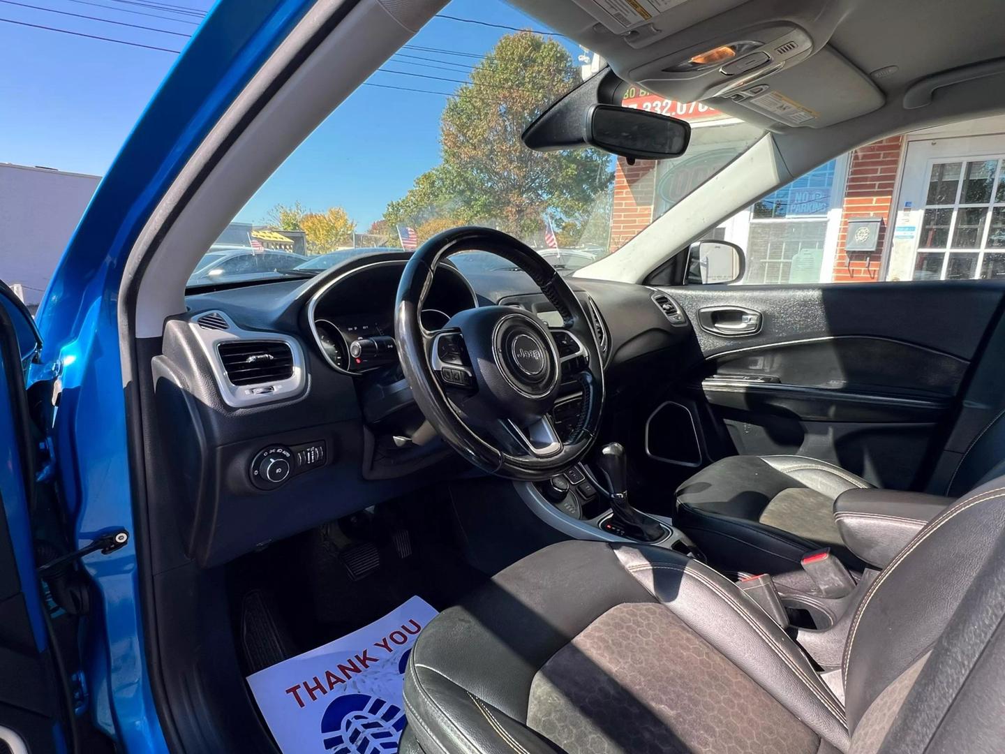 Front view of a 2020 Jeep Compass parked outdoors, showcasing its bold design and rugged build.