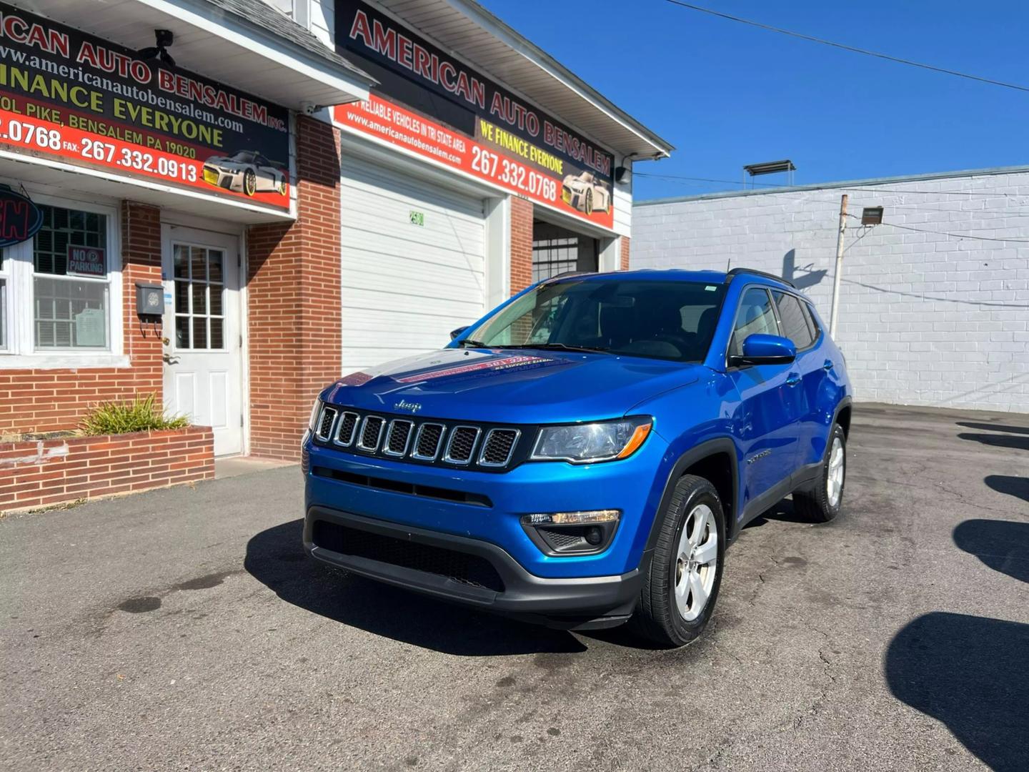 Front view of a 2020 Jeep Compass parked outdoors, showcasing its bold design and rugged build.