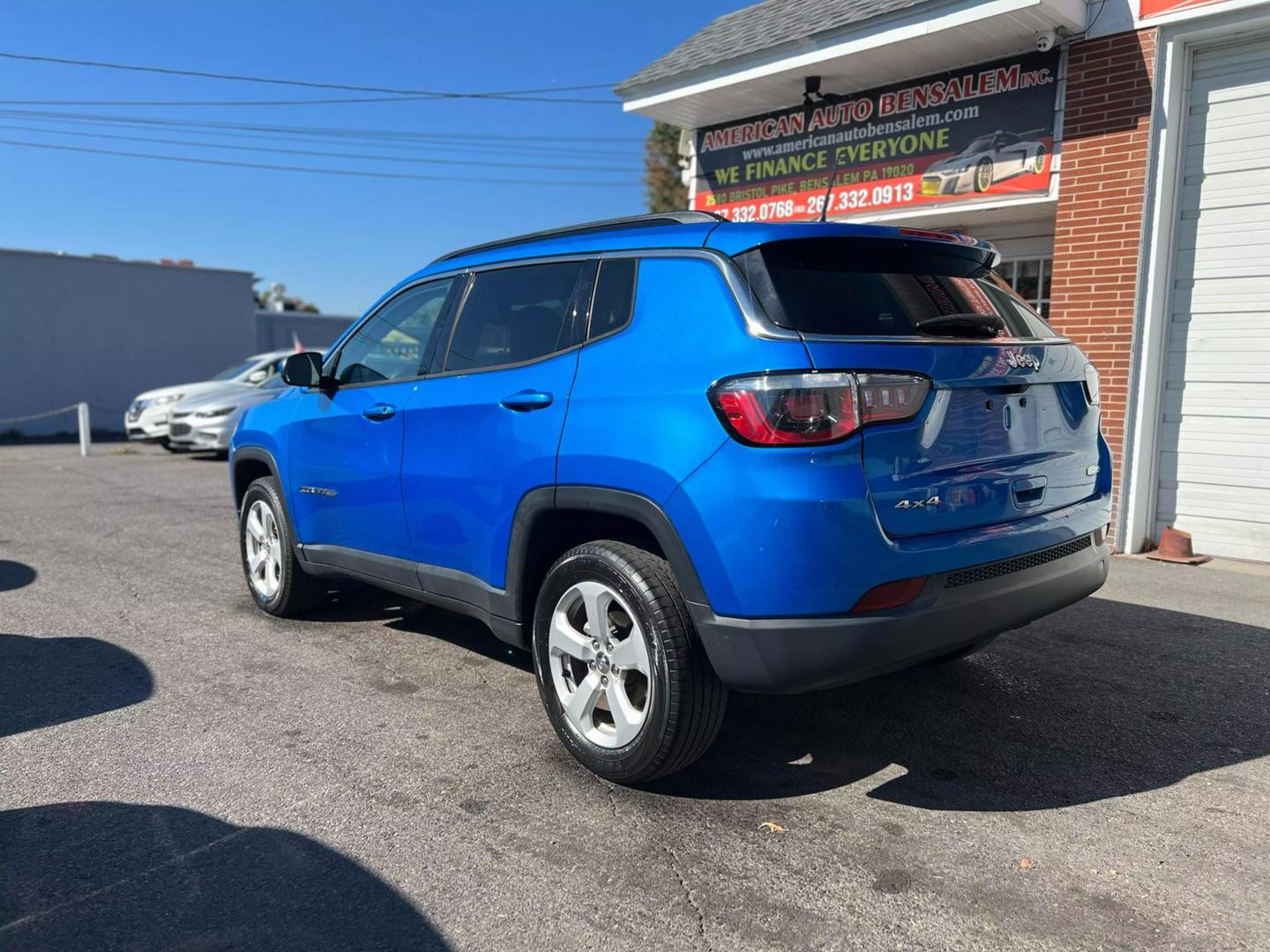 Front view of a 2020 Jeep Compass parked outdoors, showcasing its bold design and rugged build.