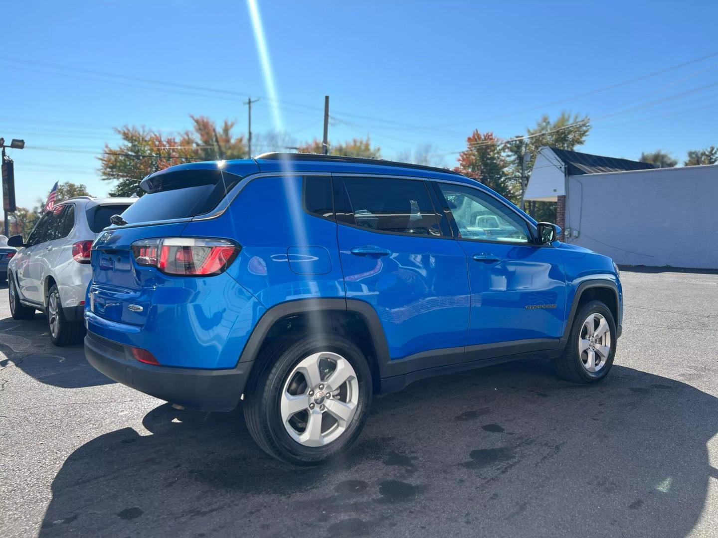 Front view of a 2020 Jeep Compass parked outdoors, showcasing its bold design and rugged build.