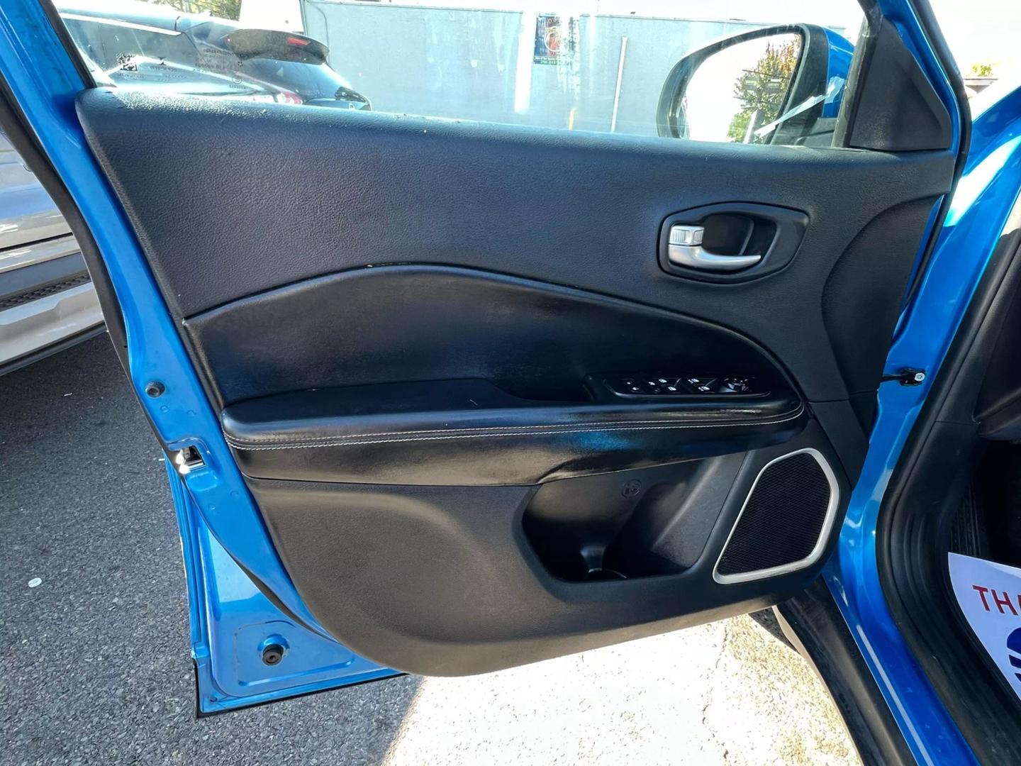 Front view of a 2020 Jeep Compass parked outdoors, showcasing its bold design and rugged build.