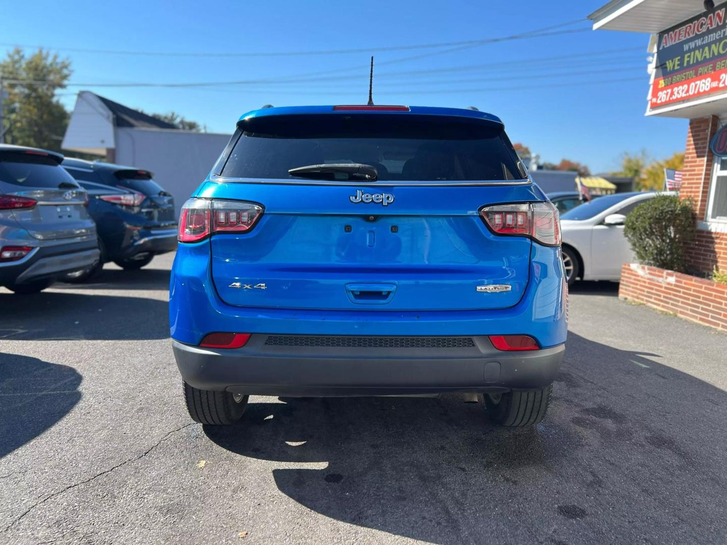 Front view of a 2020 Jeep Compass parked outdoors, showcasing its bold design and rugged build.