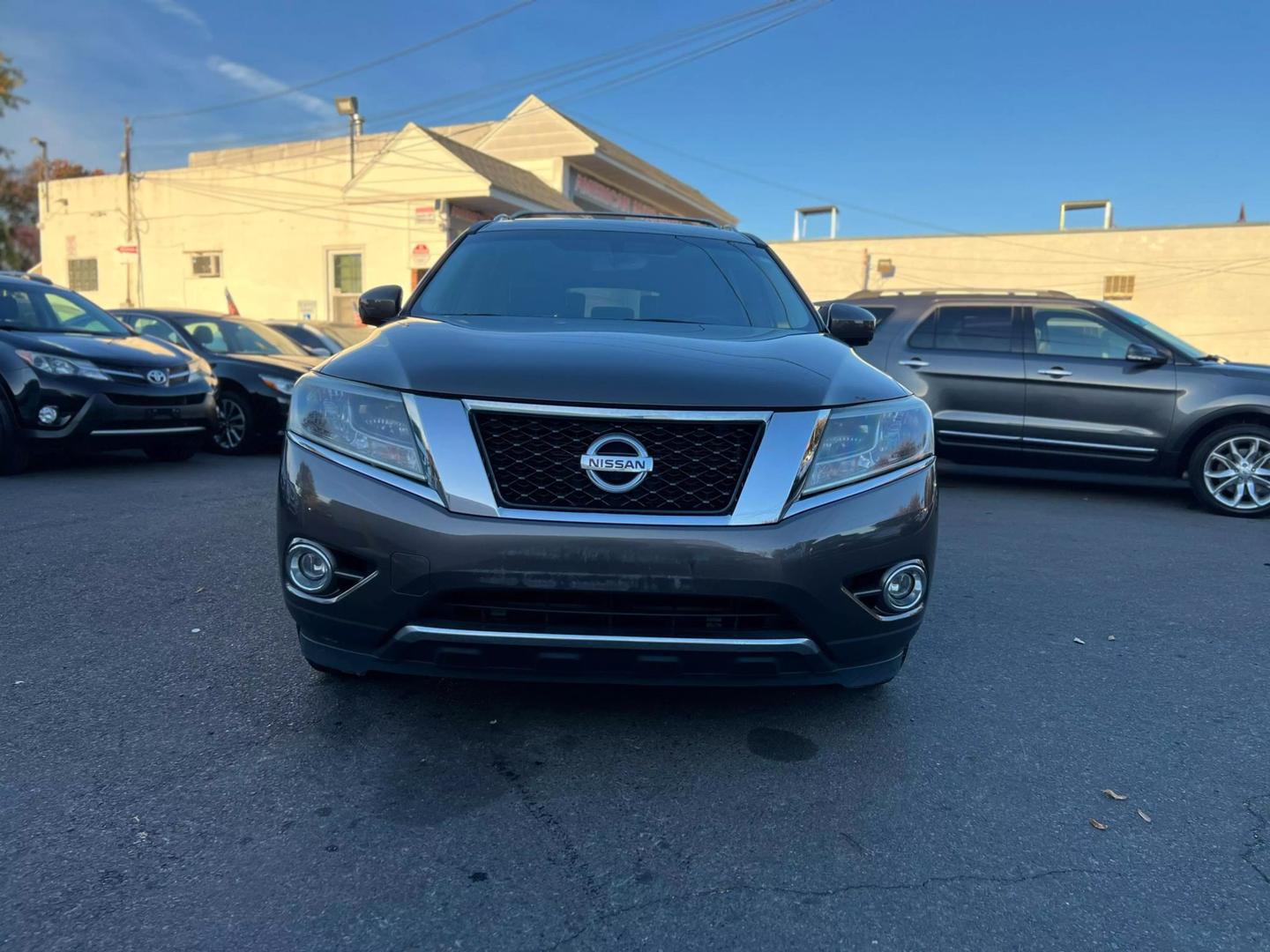 2016 Nissan Pathfinder, highlighting its sleek design, prominent grille, and stylish headlights.