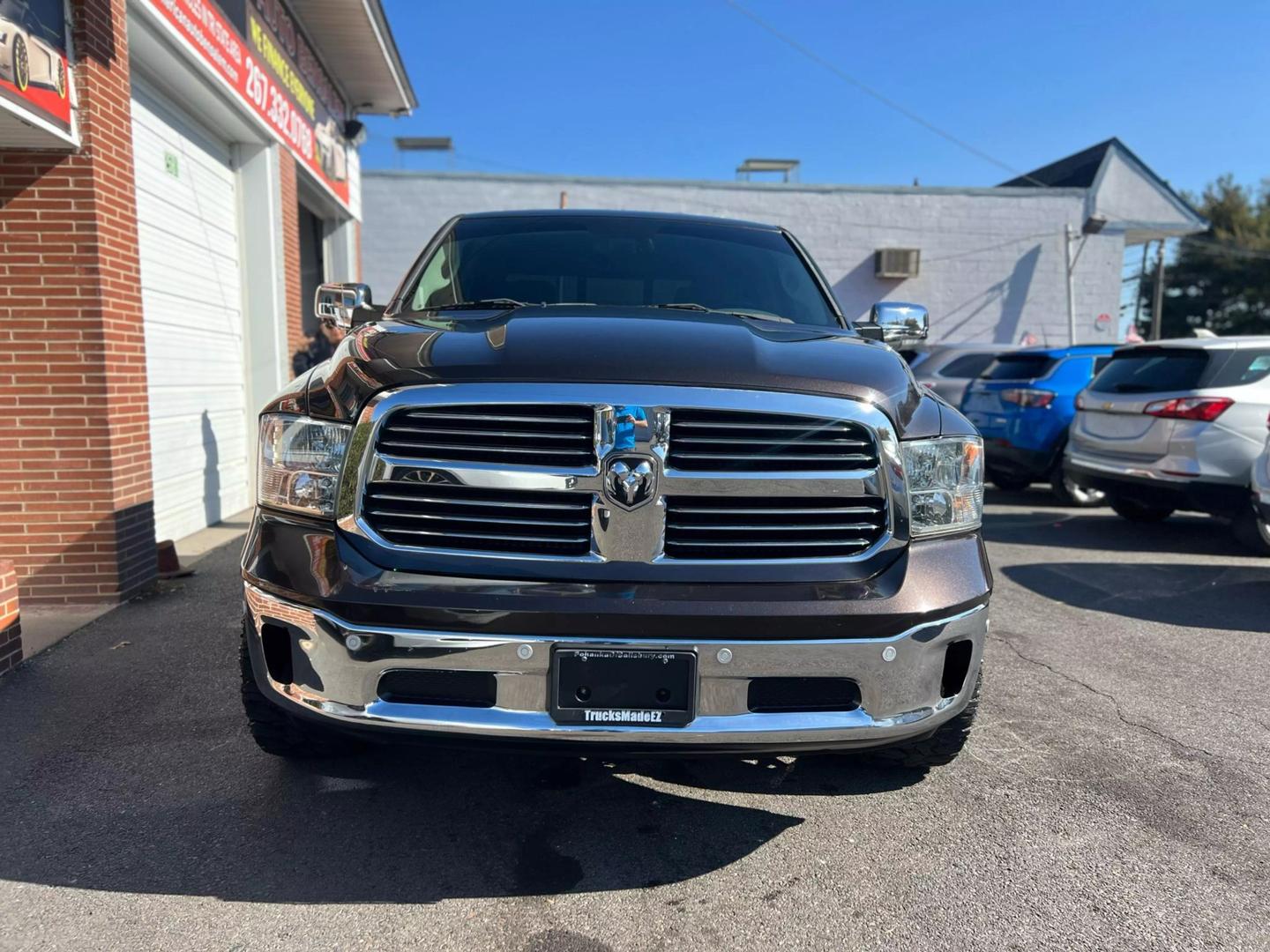 2017 RAM 1500 Crew Cab SLT Pickup in black with 4WD and V8 HEMI engine, featuring a spacious gray interior